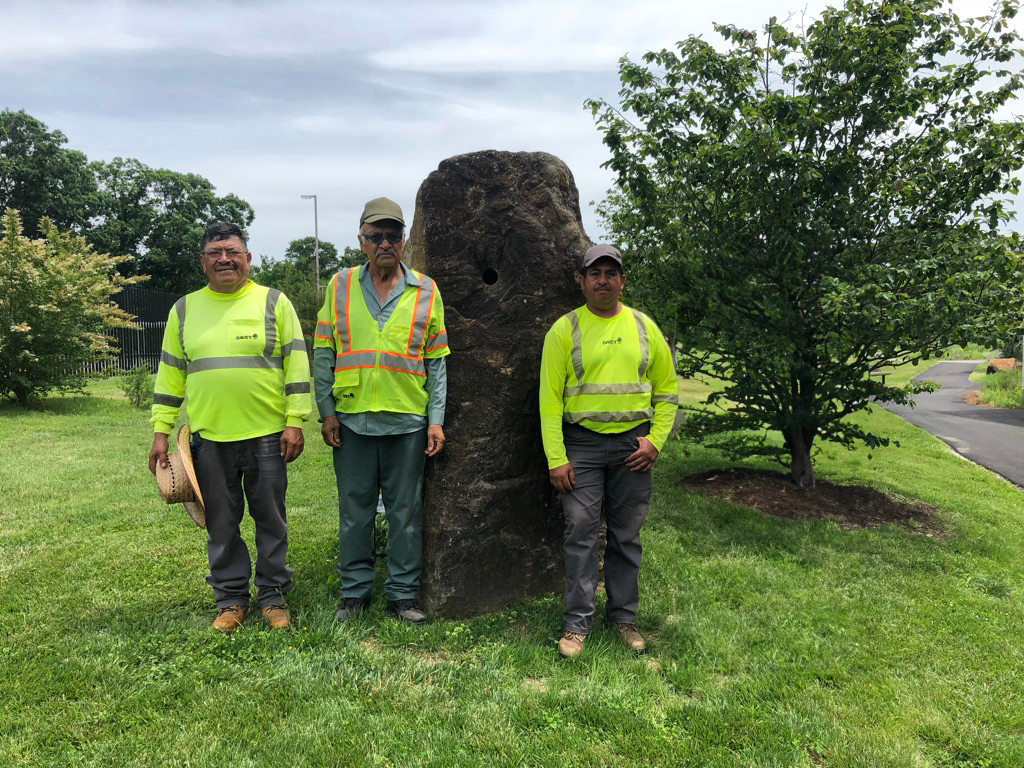 The NFATC grounds team, standing in front of the Rock of Valls Noyes