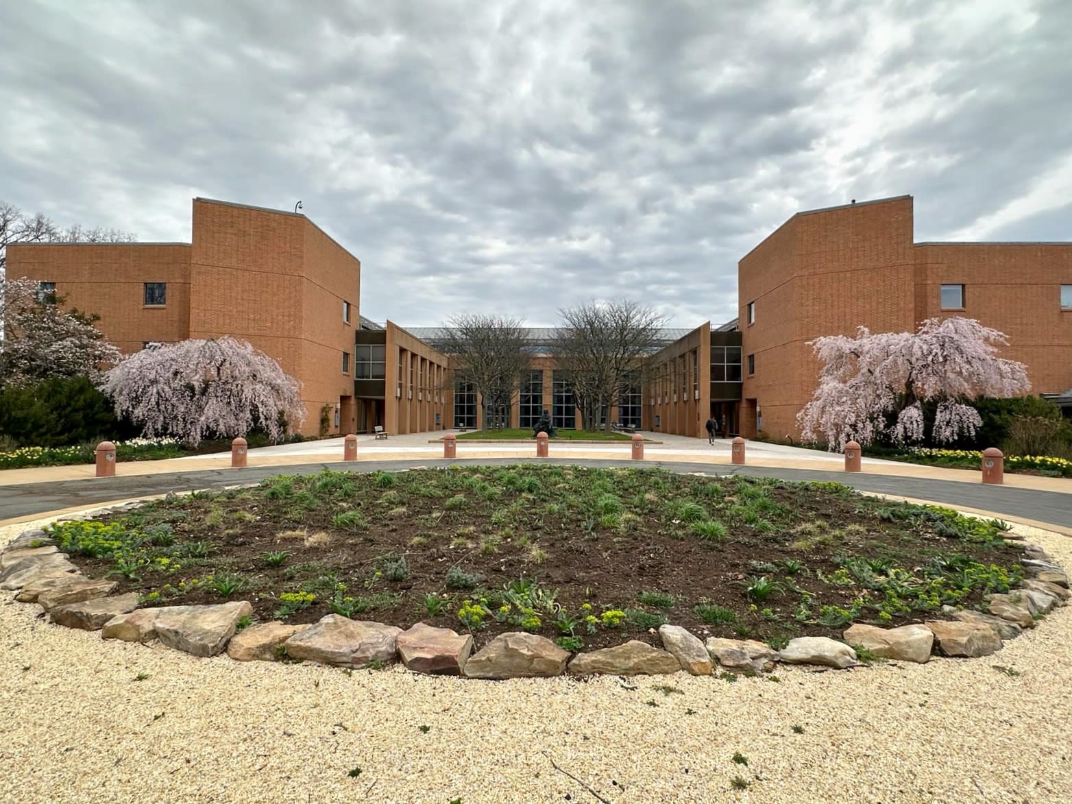 The Ceremonial Circle viewed from the entrance in spring with the trees covered in pink blossoms