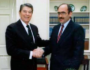 Ambassador Arnold L. Raphel shaking hands with President Ronald Reagan