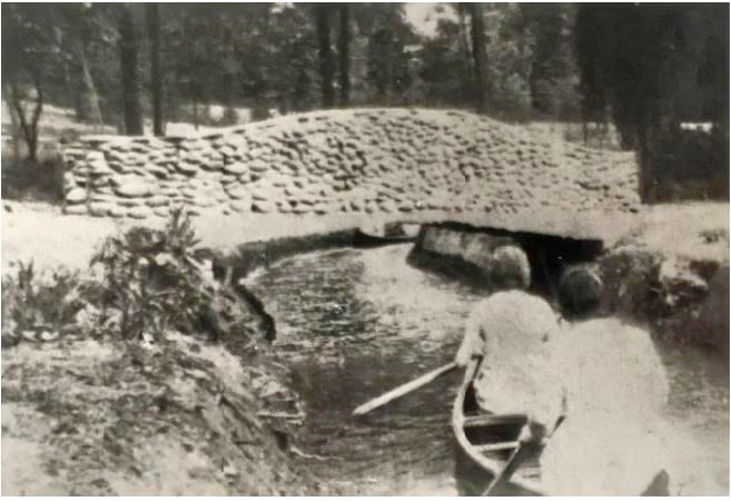 The recreational pond and one of the stone bridges in the field north of the Main Building, c. 1939.