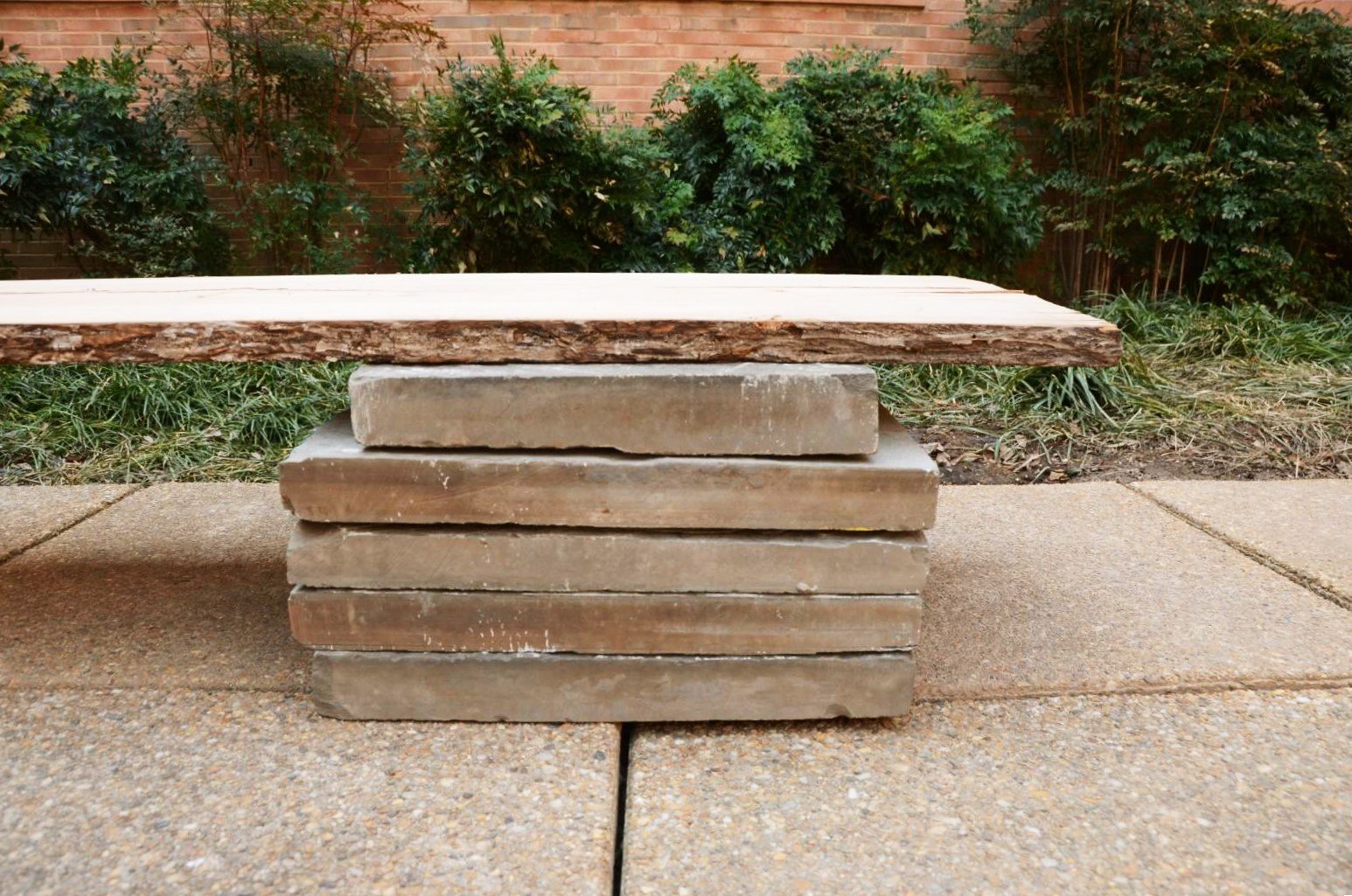 A stacked-stone bench in the Romila Thapar Garden